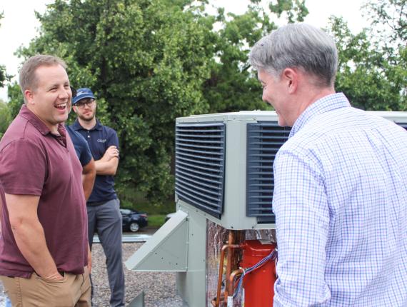 a few people standing next to hvac technology 